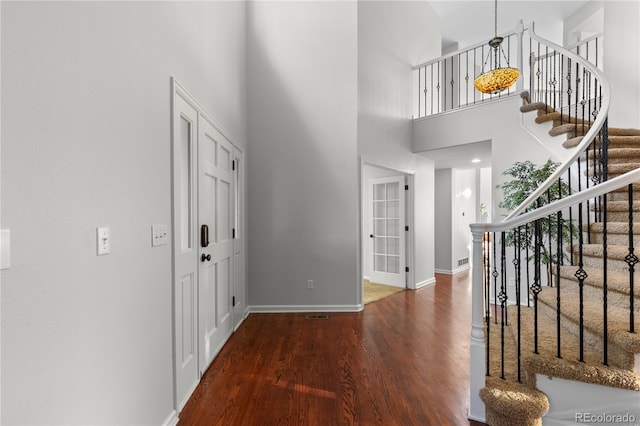 9453 Lark Sparrow Dr, Highlands Ranch, CO 80126 - entryway featuring wood finished floors, a towering ceiling, baseboards, and stairway