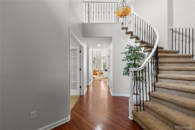 9453 Lark Sparrow Dr, Highlands Ranch, CO 80126 - foyer with wood finished floors, stairway, baseboards, and a high ceiling