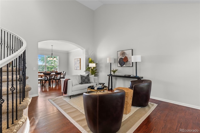 9453 Lark Sparrow Dr, Highlands Ranch, CO 80126 - living room with arched walkways, high vaulted ceiling, wood finished floors, baseboards, and stairs