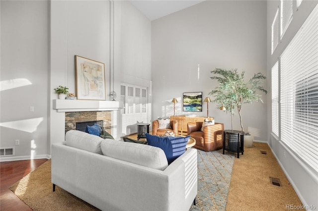 9453 Lark Sparrow Dr, Highlands Ranch, CO 80126 - living room featuring a high ceiling, a fireplace, and baseboards