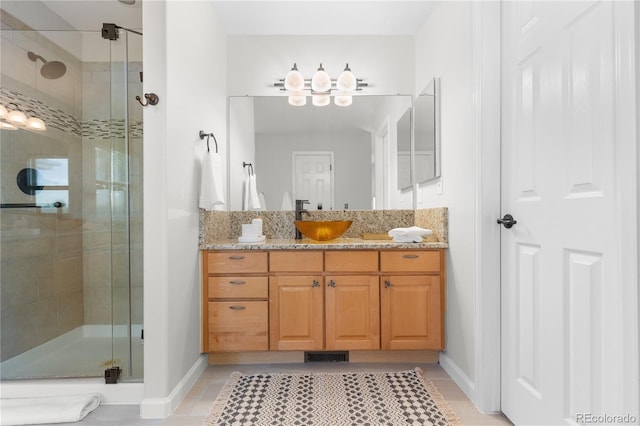9453 Lark Sparrow Dr, Highlands Ranch, CO 80126 - full bathroom featuring a stall shower, baseboards, vanity, and tile patterned floors
