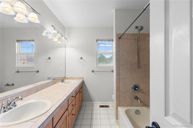 9453 Lark Sparrow Dr, Highlands Ranch, CO 80126 - bathroom with double vanity, healthy amount of natural light, tile patterned floors, and bathtub / shower combination