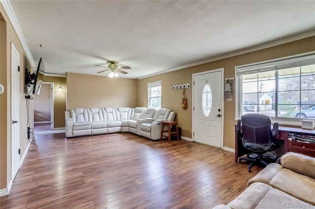 1881 E 95th Ave, Thornton, CO 80229 - living room featuring crown molding, baseboards, and wood finished floors