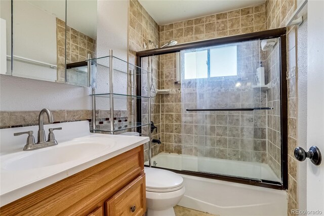 1881 E 95th Ave, Thornton, CO 80229 - full bath with bath / shower combo with glass door, vanity, and toilet