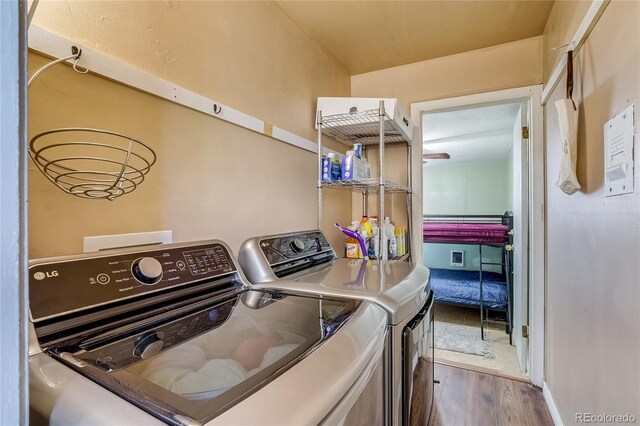 1881 E 95th Ave, Thornton, CO 80229 - clothes washing area with separate washer and dryer, baseboards, laundry area, and wood finished floors