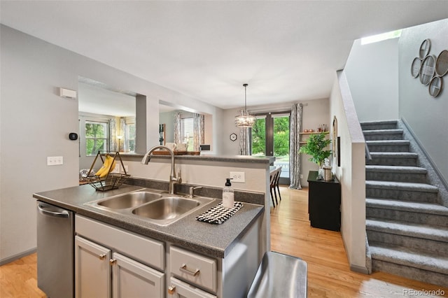 2813 Central Park Blvd, Denver, CO 80238 - kitchen with stainless steel dishwasher, a sink, dark countertops, a center island with sink, and healthy amount of natural light