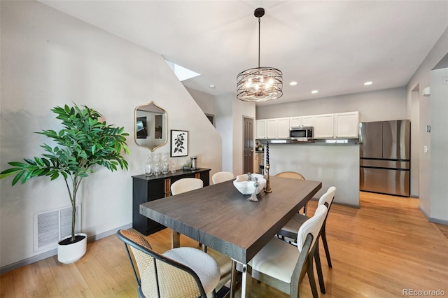 2813 Central Park Blvd, Denver, CO 80238 - dining area with a skylight, light wood finished floors, recessed lighting, a chandelier, and baseboards