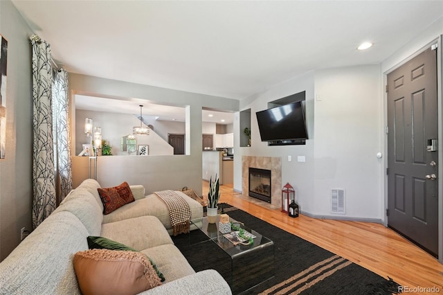 2813 Central Park Blvd, Denver, CO 80238 - living room with wood finished floors, a tiled fireplace, recessed lighting, and baseboards