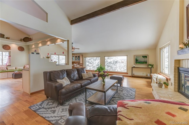 living area with light wood finished floors, plenty of natural light, and a fireplace