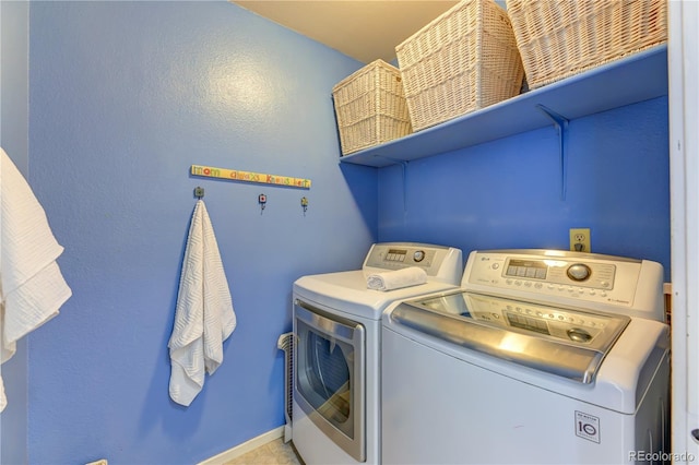 laundry room with laundry area, baseboards, and separate washer and dryer