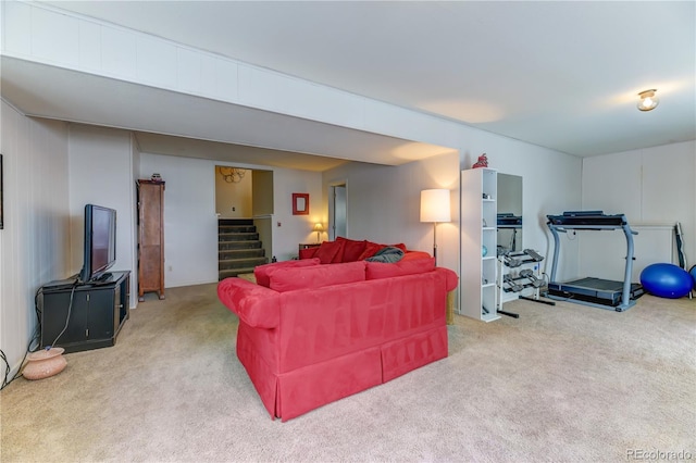 carpeted living room featuring stairway