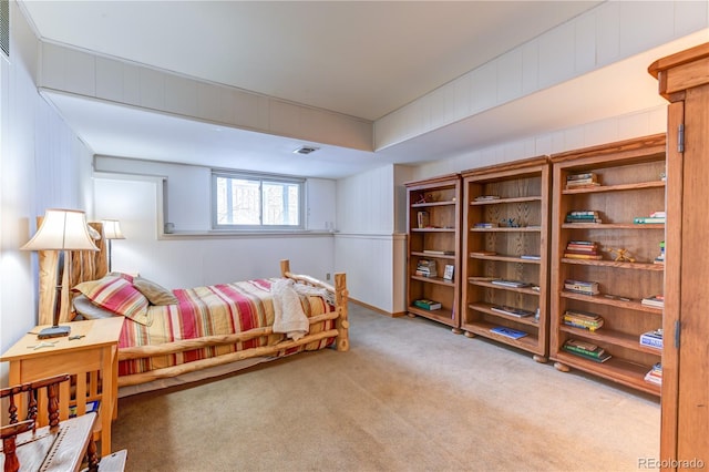 carpeted bedroom featuring visible vents