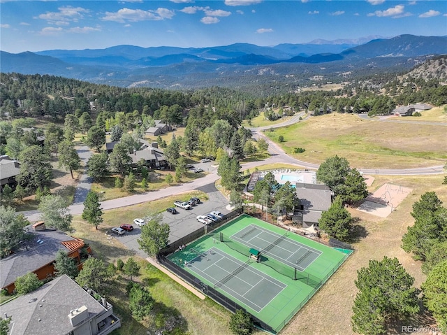 birds eye view of property featuring a mountain view and a wooded view