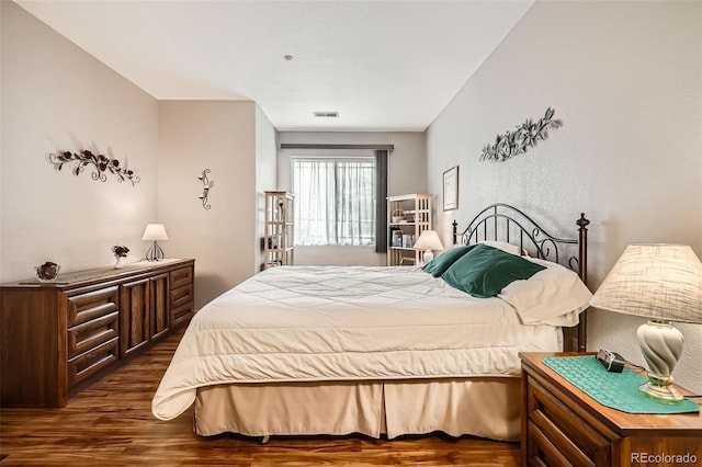 bedroom featuring visible vents and dark wood-type flooring