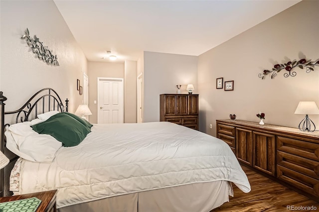 bedroom with dark wood-style flooring