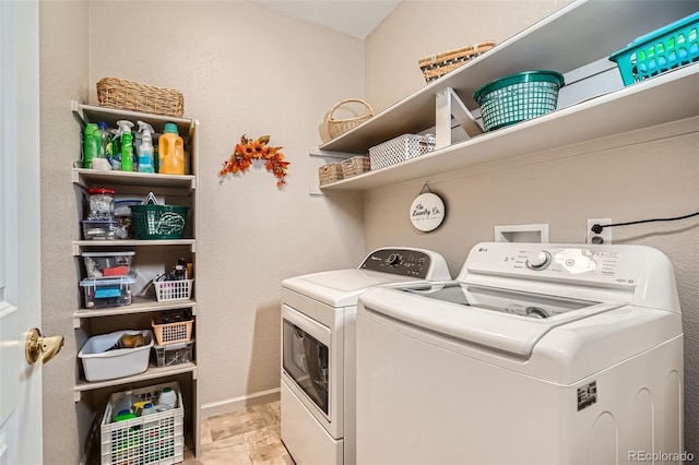 laundry area featuring laundry area, baseboards, and separate washer and dryer