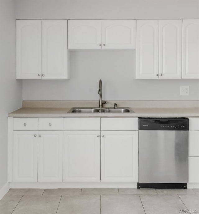 kitchen with a sink, white cabinets, light countertops, and dishwasher