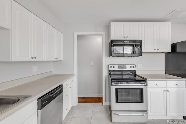 kitchen with appliances with stainless steel finishes, white cabinets, and light countertops