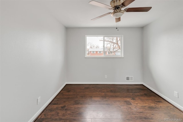 empty room featuring dark wood-style floors, baseboards, visible vents, and ceiling fan