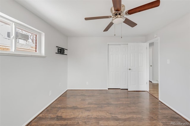 unfurnished bedroom with a ceiling fan, a closet, baseboards, and dark wood-style flooring