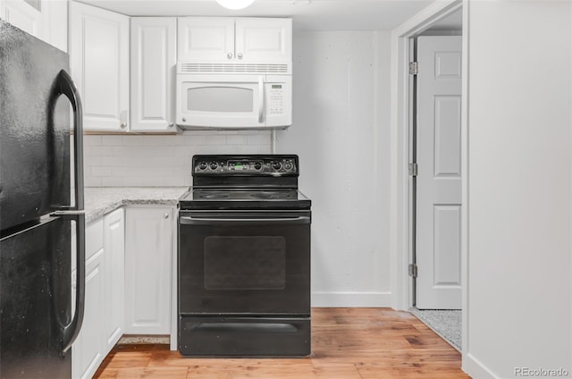 kitchen featuring tasteful backsplash, black appliances, light stone counters, and white cabinets