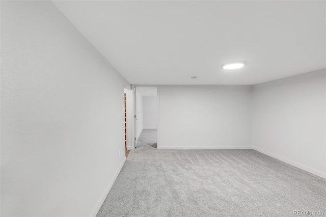 unfurnished room with carpet flooring and baseboards