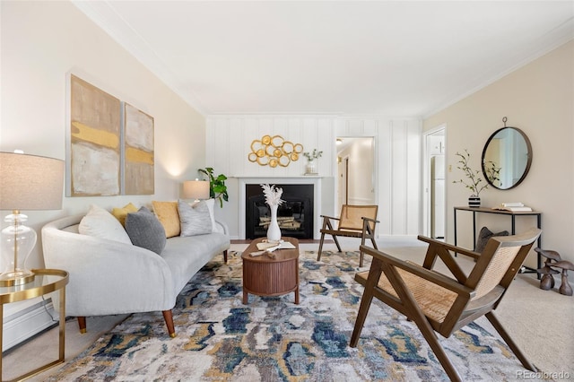 carpeted living area with crown molding and a glass covered fireplace