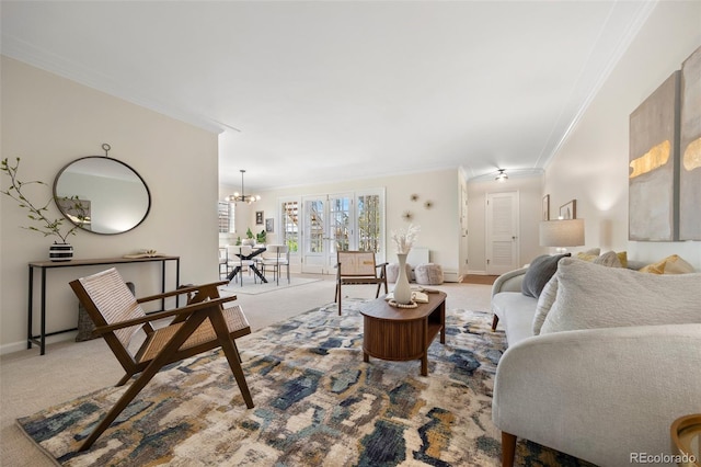 living room featuring a chandelier, ornamental molding, carpet flooring, and baseboards
