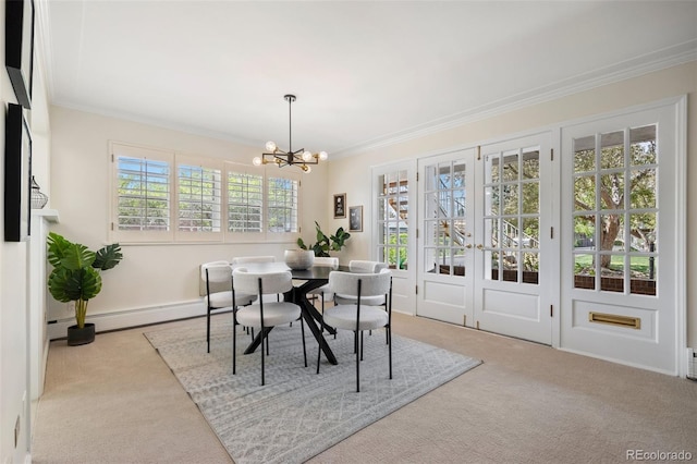 carpeted dining room featuring french doors, a baseboard heating unit, ornamental molding, baseboards, and a notable chandelier