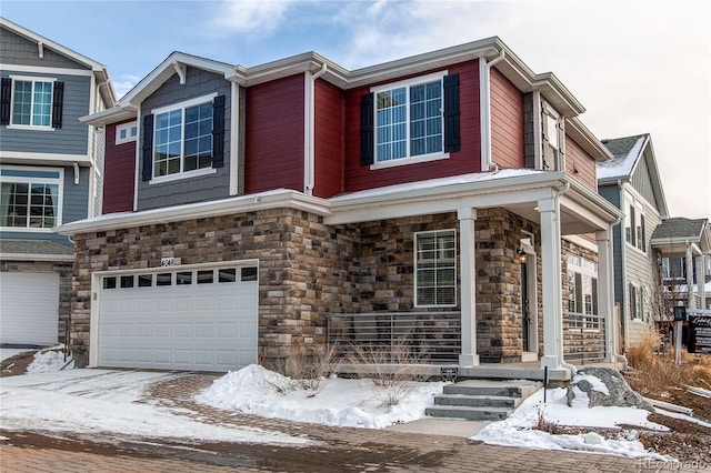 view of front of house featuring an attached garage and stone siding