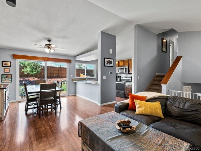 11877 W Bowles Cir, Littleton, CO 80127 - living area featuring ceiling fan, wood finished floors, and vaulted ceiling