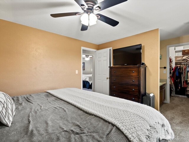 11877 W Bowles Cir, Littleton, CO 80127 - carpeted bedroom featuring a spacious closet and ceiling fan