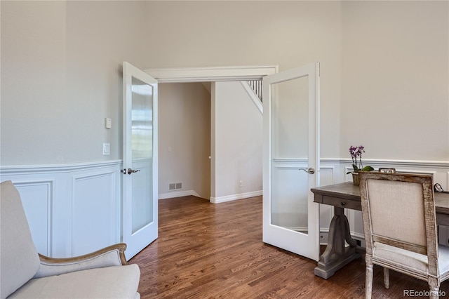 home office featuring dark hardwood / wood-style flooring and french doors