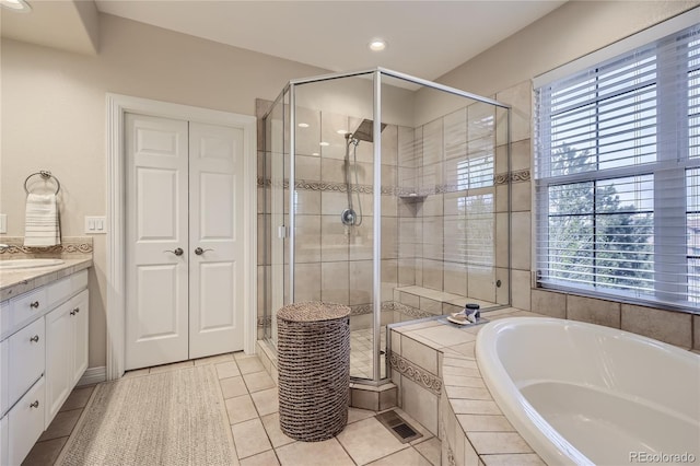 bathroom with tile patterned flooring, plenty of natural light, vanity, and separate shower and tub