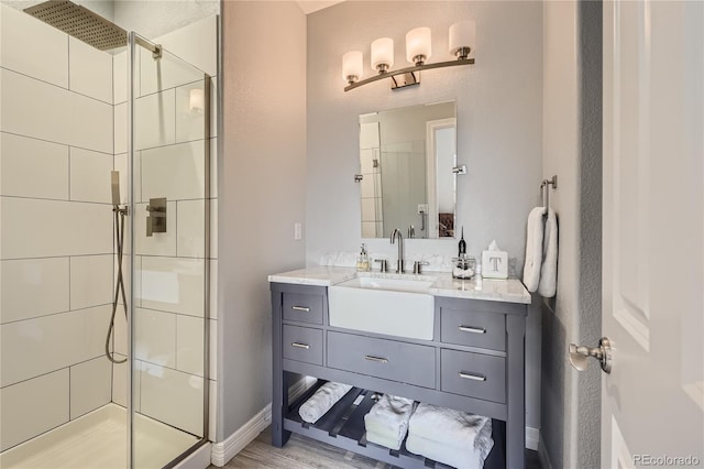 bathroom with an enclosed shower, hardwood / wood-style flooring, and vanity