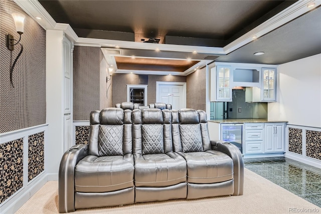 home theater room featuring a tray ceiling, tile patterned flooring, wine cooler, and ornamental molding