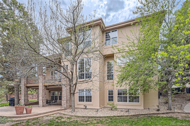 exterior space with a balcony and a patio area