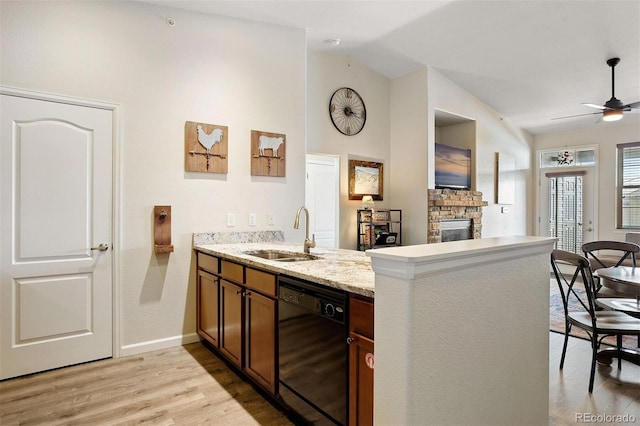 kitchen featuring sink, black dishwasher, vaulted ceiling, and kitchen peninsula