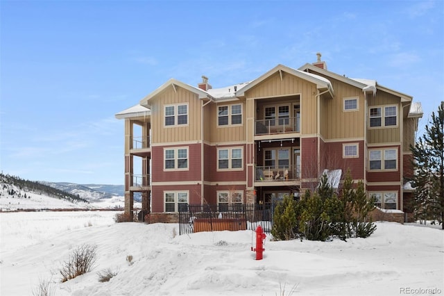 snow covered property with a mountain view