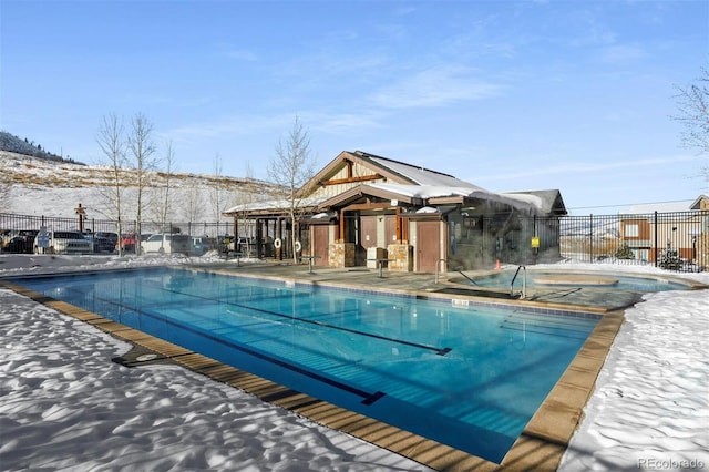 snow covered pool featuring a patio area