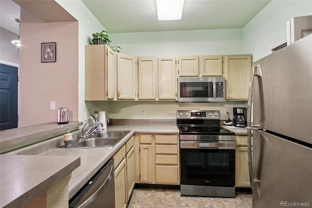 4545 Wheaton Dr Unit B210, Fort Collins, CO 80525 - kitchen featuring appliances with stainless steel finishes, light brown cabinetry, and light countertops