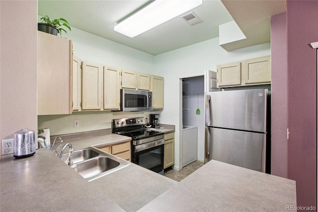 4545 Wheaton Dr Unit B210, Fort Collins, CO 80525 - kitchen with stainless steel appliances, light brown cabinetry, and light countertops