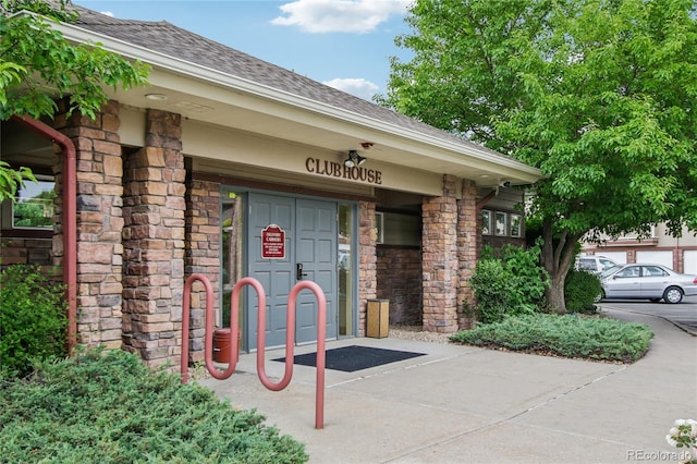 4545 Wheaton Dr Unit B210, Fort Collins, CO 80525 - view of exterior entry featuring a shingled roof