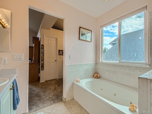 bathroom with tile patterned floors, vanity, and a washtub