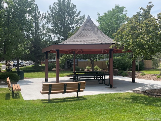 surrounding community with a gazebo and a yard