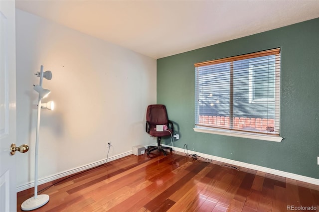 spare room featuring wood-type flooring