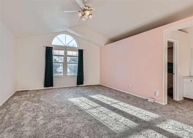 unfurnished room with ceiling fan, vaulted ceiling, and carpet