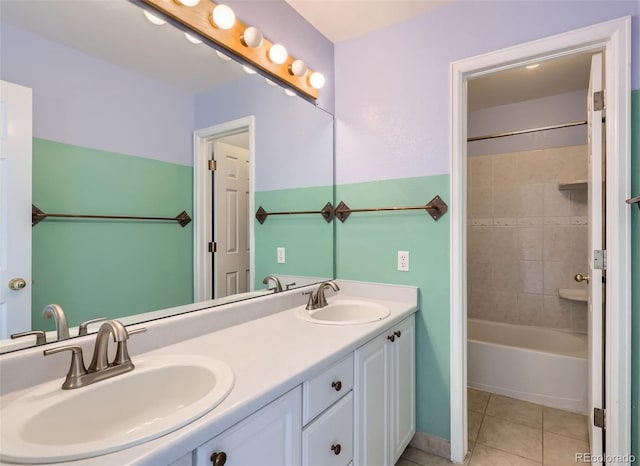 bathroom with tiled shower / bath combo, vanity, and tile patterned floors