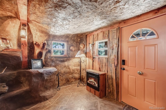 bathroom featuring a wood stove and a wealth of natural light