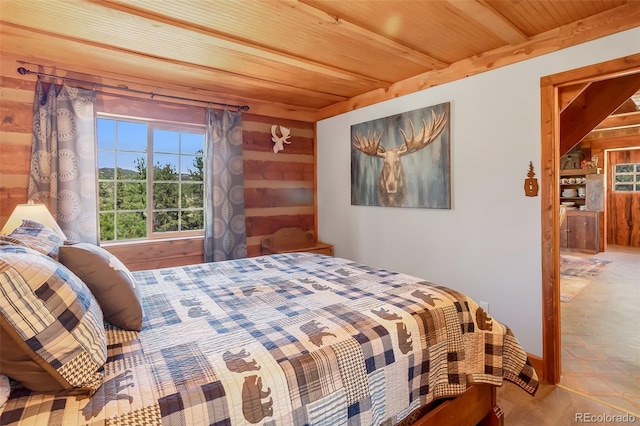 bedroom with wood ceiling and wood walls